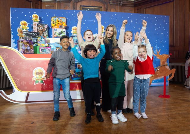 Sports presenter Helen Skelton poses with children at the Toy Retailers Association (TRA)'s Dream Toys exhibition at London's Goodenough College.