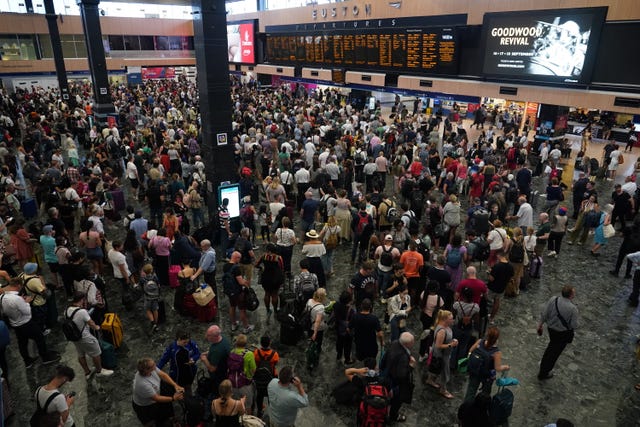 A crowd of passengers at Euston station in London following train cancellations during record temperatures in July 2022