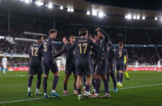 Jack Grealish celebrates scoring England's first goal as team-mates gather around him