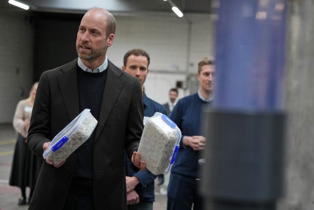 The Prince of Wales holds two boxes containing waste products during a visit to 2025 Earthshot Prize finalist Matter, a pioneer in sustainable technology based in Bristol, to learn about its innovative filtration technology system designed to prevent microplastics from entering our waterways and oceans