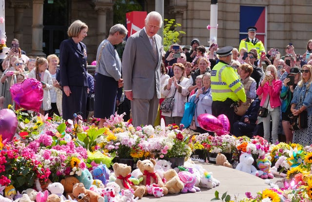 The King views the flowers and tributes outside the Atkinson Art Centre in Southport 