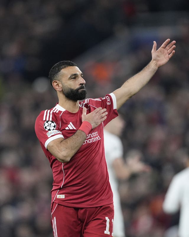 Liverpool’s Mohamed Salah taps the badge after scoring