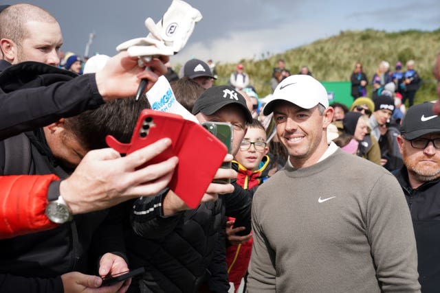 Rory McIlroy poses for pictures with fans