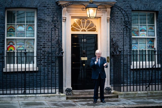 Prime Minister Boris Johnson stands outside 10 Downing Street in London as he joins in the applause to salute local heroes during Thursday’s nationwide clap for carers