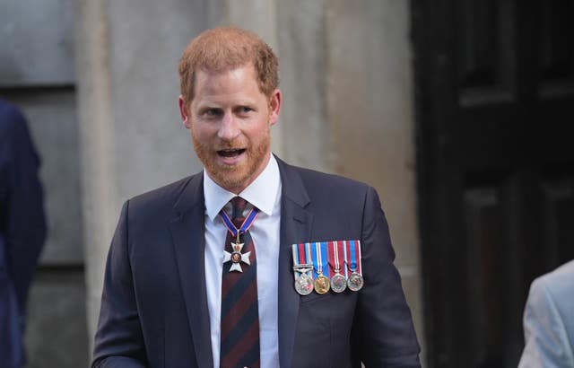 Harry wearing a suit and his medals as he leaves St Paul's Cathedral