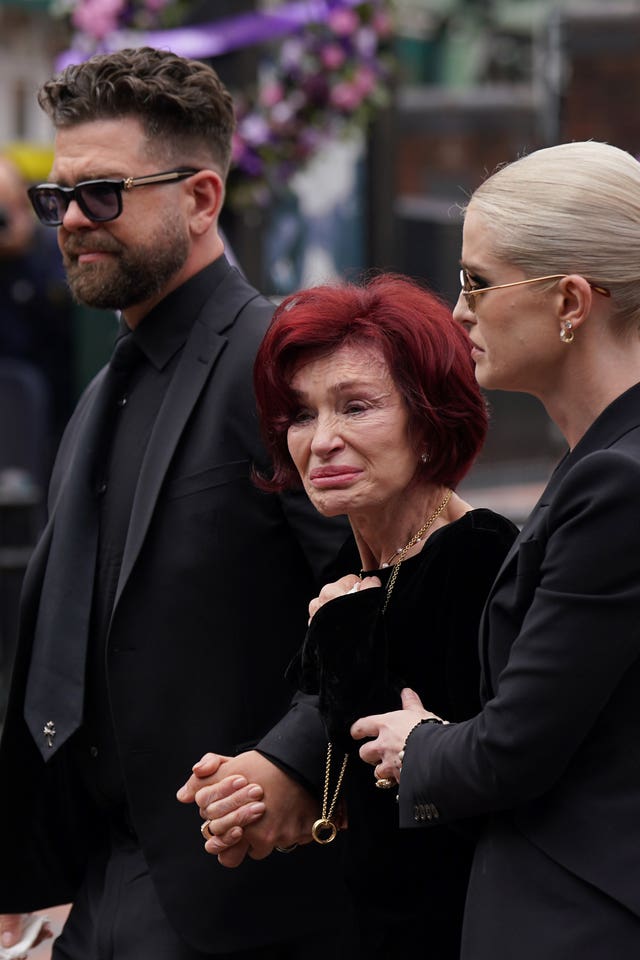 Jack, Sharon and Kelly Osbourne view the messages and floral tributes left at the Black Sabbath Bridge bench on Broad Street in Birmingham in memory of Black Sabbath front man Ozzy Osbourne 