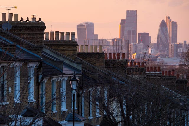 A row of houses with the London skyline in the background