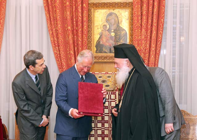 Charles receives a gift of an Icon of the Virgin Mary from His Beatitude Archbishop Ieronymos II of Athens and All Greece (Andrew Matthews/PA)