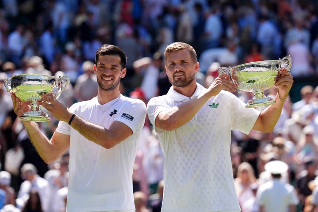 Julian Cash, left and Lloyd Glasspool hold their Wimbledon trophies 