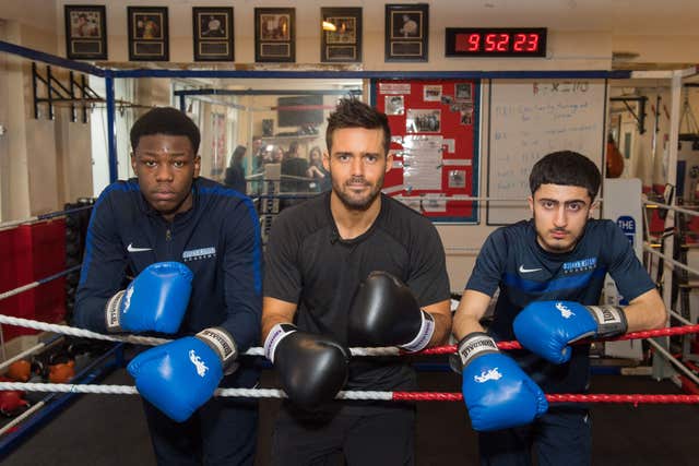 Spencer Matthews (centre) with students Tipoti (left) and Ali (Dominic Lipinski/PA)