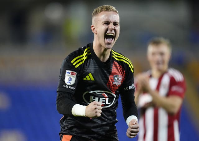 Exeter City goalkeeper Joe Whitworth celebrates fans