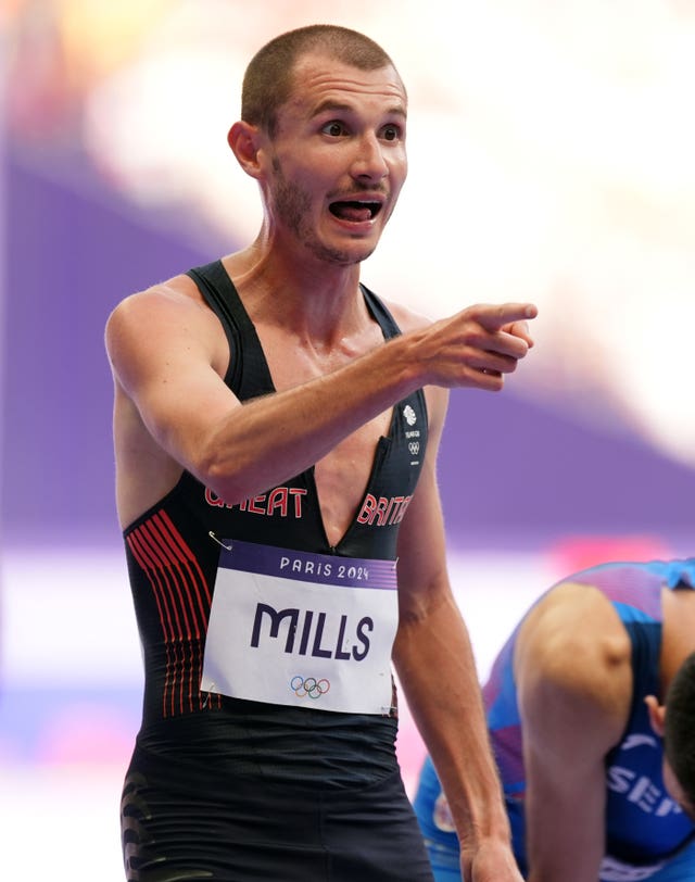 Great Britain's George Mills points after he had fallen in the 5000 metres heats. 