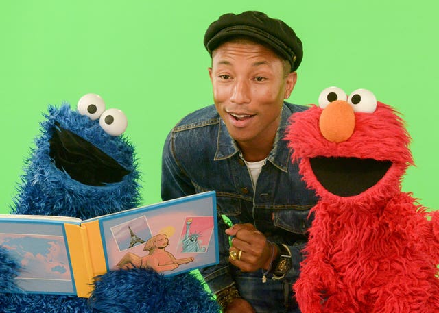 Elmo (right) with Pharrell WIlliams and the Cookie Monster (Zach Hyman/AP)