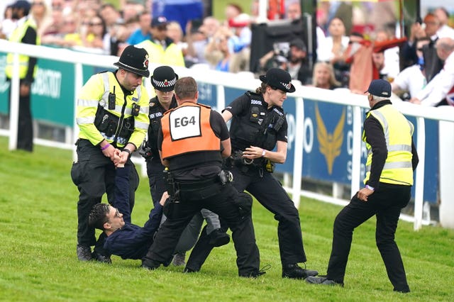 The protester was removed from the track at Epsom