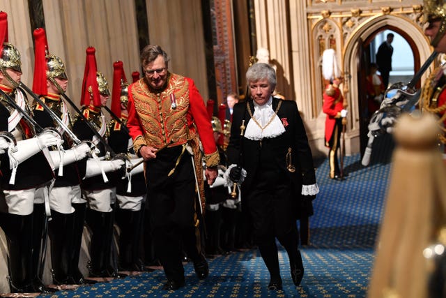 Lady Usher of the Black Rod Sarah Clarke arrives through the Norman Porch for the State Opening