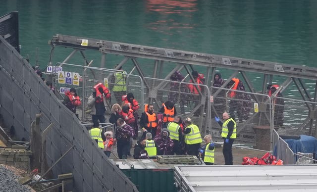 A group of people thought to be migrants are brought in to Dover,