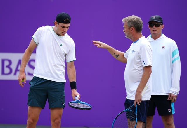 Jack Draper, left, talks to coach James Trotman as Wayne Ferreira, background, looks on