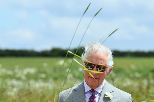 The Prince of Wales views soil samples during his visit to the specialist farming centre