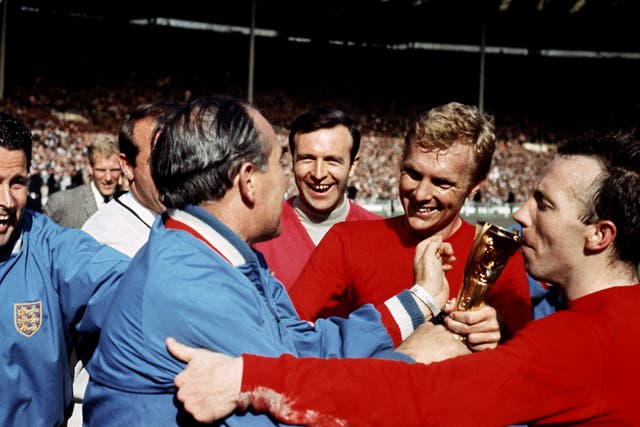 Jimmy Armfield looks on in the background as Alf Ramsey greets Bobby Moore after England win the World Cup