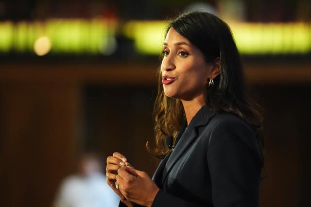 Claire Coutinho speaking to an audience on stage at a Conservative party event