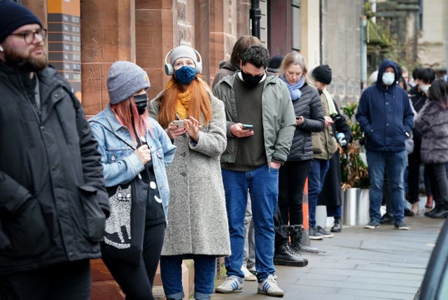 People queue along Junction Place, Edinburgh, for the vaccination centre at the NHS Scotland Leith Community Treatment Centre, as the coronavirus booster vaccination programme is ramped up to an unprecedented pace of delivery, with every eligible adult in Scotland being offered a top-up injection by the end of December. 