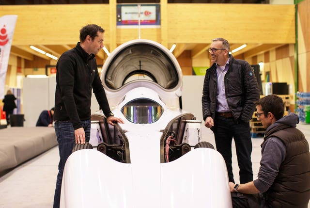 Ian Warhurst (top right) with the supersonic car at its new home at SGS Berkeley Green University Technical College on the Gloucestershire Science and Technology Park (Grafton LSR/PA)