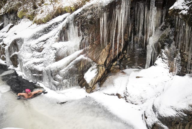 Alice Goodridge swims the frozen waters of the River Calder in Glen Banchor in the Cairngorms National Park 