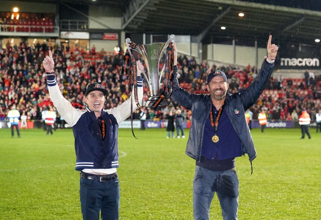 Wrexham co-owners Rob McElhenney and Ryan Reynolds celebrate with the National League trophy