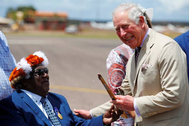 Charles receives a woomera, a traditional spear thrower, from Galarrwuy Yunupingu, an aboriginal leader (Phil Noble/PA)