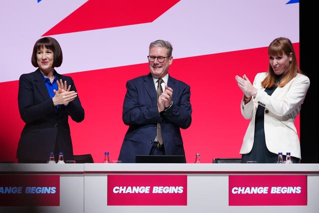 Chancellor Rachel Reeves, Prime Minister Sir Keir Starmer and Deputy Prime Minister Angela Rayner clap their hands during the Labour Party conference in Liverpool