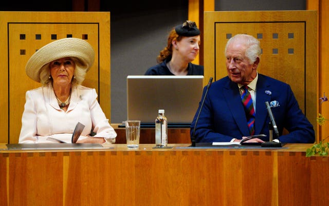 The King and Queen sit in the Senedd chamber