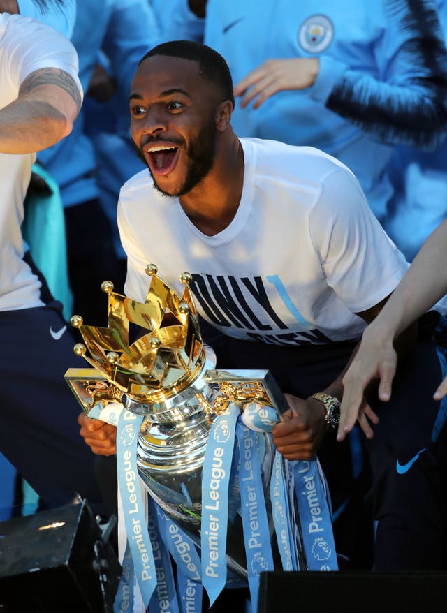 Manchester City’s Raheem Sterling celebrates with the Premier League trophy during a parade in Manchester