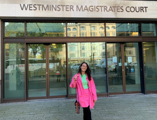 Sofia Fernandes Pontes in pink and smiling outside a court