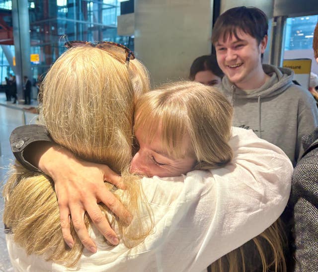Sarah Short hugging family at Heathrow