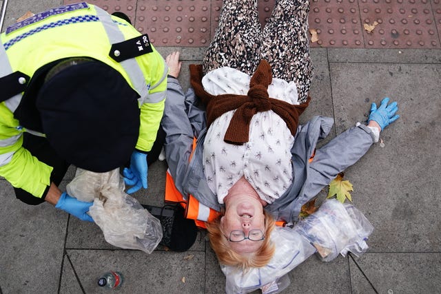 Police remove activists from Just Stop Oil during their protest on Cromwell Road, London, near to the Victoria & Albert Museum October 19, 2022