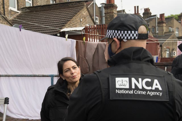 Priti Patel talks to a National Crime Agency officer