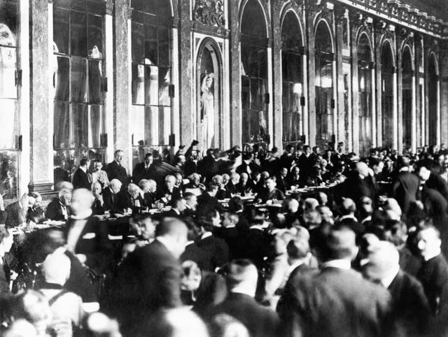 Officials sign the peace terms of the treaty at Versailles