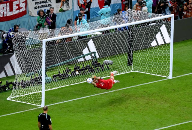 Emiliano Martinez saves from Netherlands captain Virgil van Dijk, not pictured, during the World Cup quarter-final shoot-out