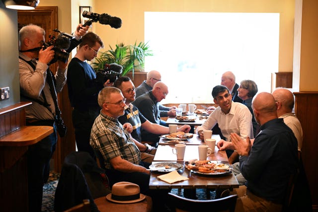 Prime Minister Rishi Sunak (centre right) joined veterans at a community breakfast
