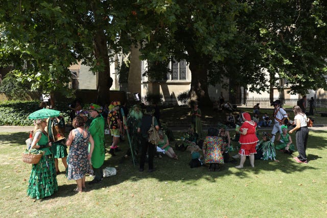 Morris dancers gather in the shade outside Parliament