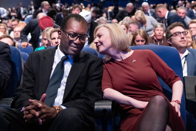 Liz Truss leans over to speak to chancellor Kwasi Kwarteng at the Tory Party conference in Birmingham