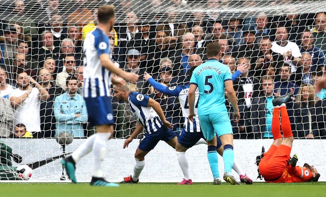 Hugo Lloris, right, lies injured as Neal Maupay, centre left, celebrates scoring for Brighton