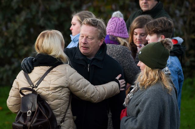 Mr Sutherland is comforted during a vigil for his daughter after her body had been found (Andrew Matthews/PA)