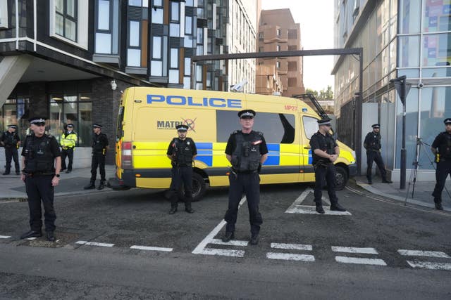 Police officers and a police van block the vehicle entrance at Liverpool Magistrates’ Court