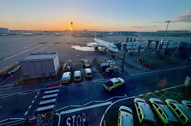 A British Airways plane at Heathrow airport, London as seen from Terminal 5 gate C at sunrise
