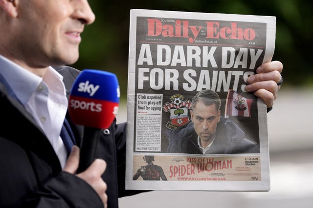 A copy of the Southern Daily Echo, featuring Southampton manager Tonda Eckert, is held up during a live Sky Sports broadcast outside Staplewood Campus, Southampton Football Club Training Ground