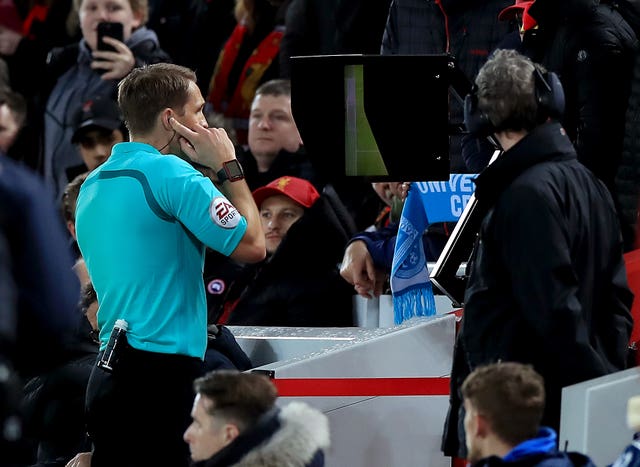 Match referee Craig Pawson uses the Video Assistant Referee to give a penalty to Liverpool.