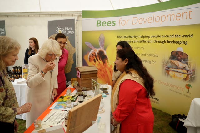 The Duchess of Cornwall trying some Indian honey at the Bees for Development Garden Party in 2019