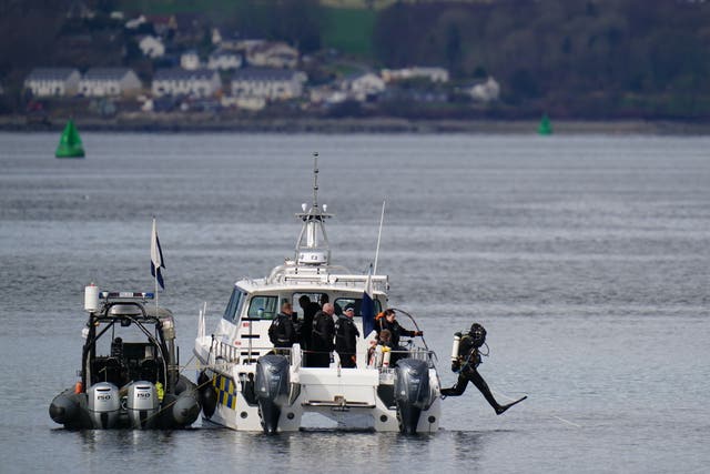 Police diver jumping into the sea from a boat