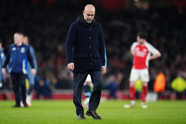 Pep Guardiola walks with his head down